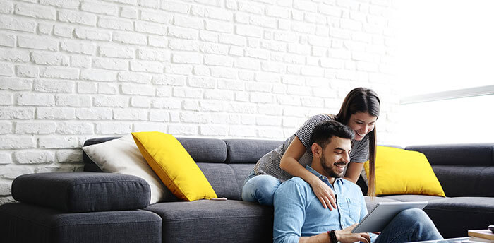 Couple looking at loan options on tablet at home