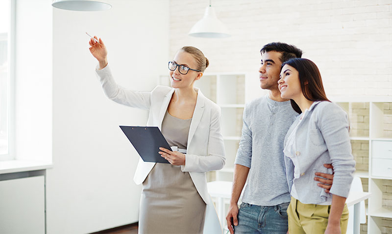 Realtor showing aspects of home to couple