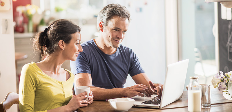 Couple drafting letter together on laptop