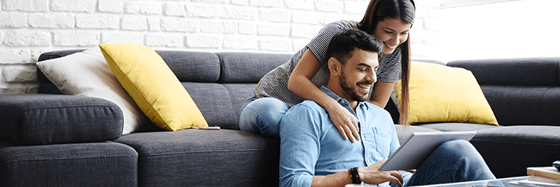 Couple looking at loan options on tablet at home