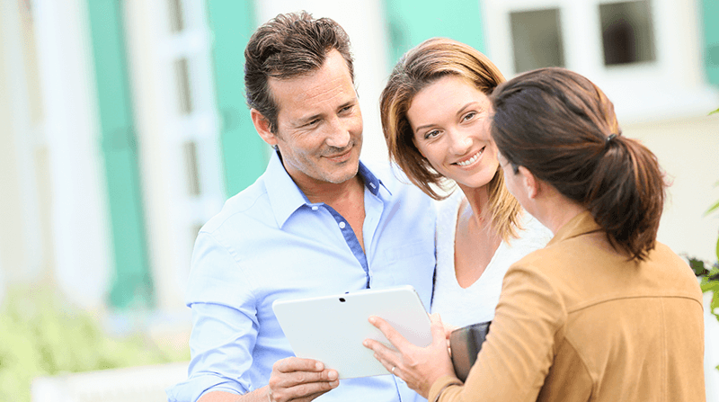 Lender showing couple details on tablet