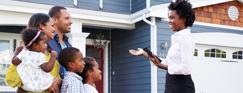 Family being shown potential home by real estate agent