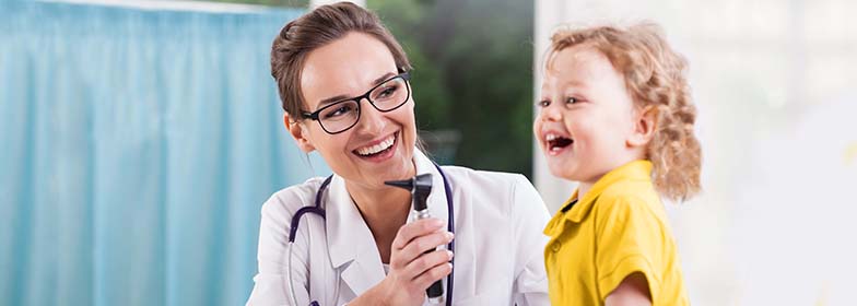 Female doctor helping young girl