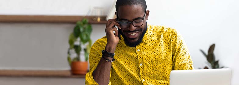 Man talking on phone at desk