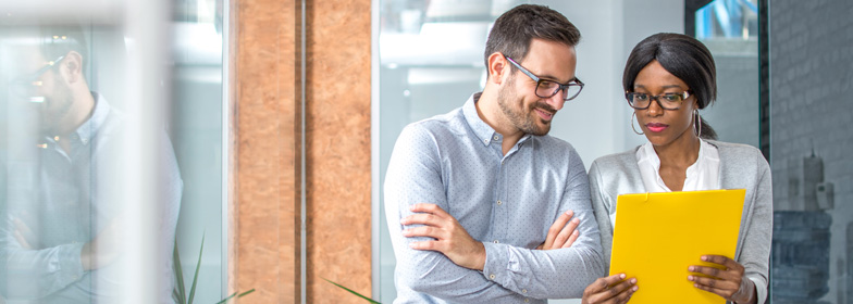 Coworkers reviewing documents in office