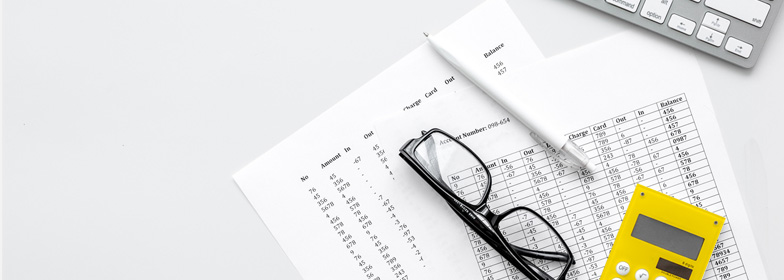 Loan documents and calculator on a desk