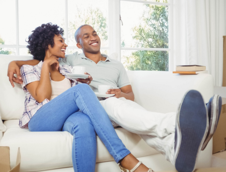 Smiling couple sitting on couch