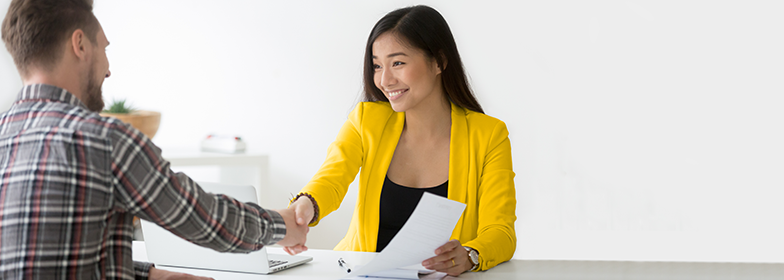 A loan officer shaking hands with their client