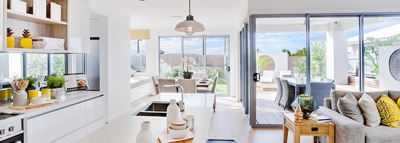 A kitchen over looking the dining area and backyard