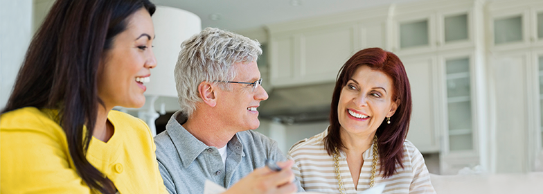 An elderly couple talking to their loan officer