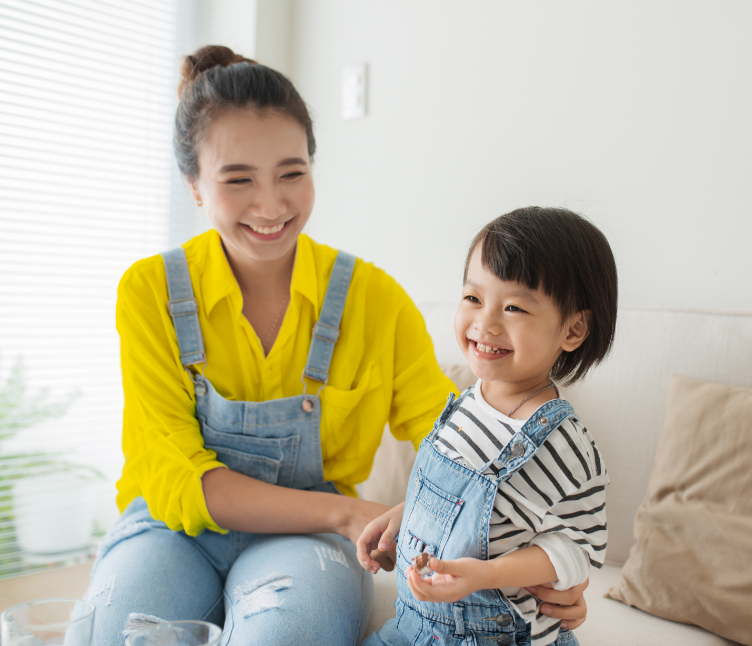 Smiling mother and child on couch