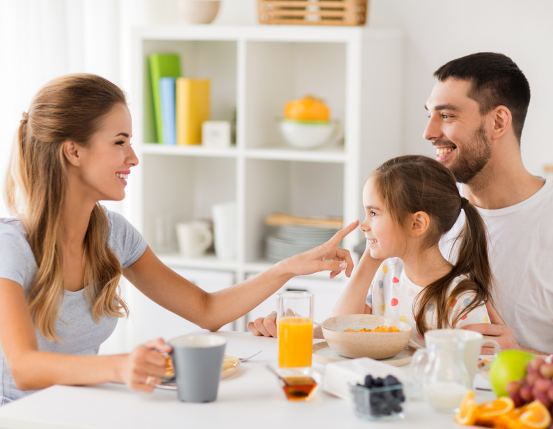 A family smiling in the kitchen