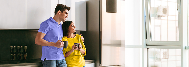 A husband and wife enjoying coffee in their kitchen