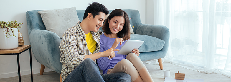 A couple looking at a tablet together