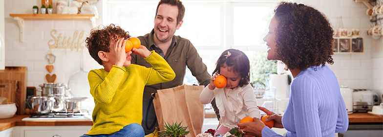 A family unloading groceries together