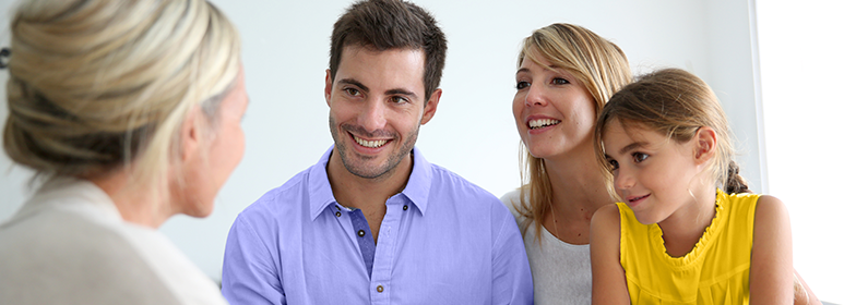 A family taking with their loan officer