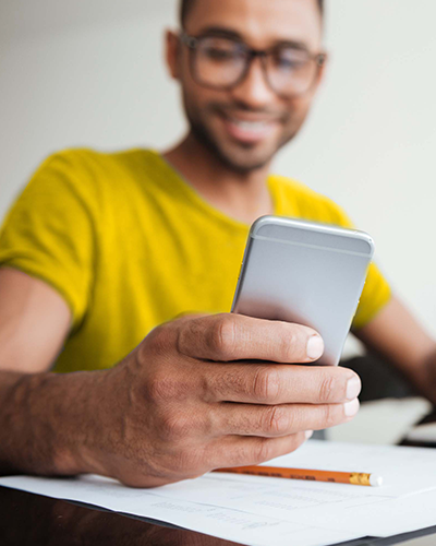 Smiling man looking at phone