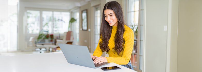 Smiling woman using laptop