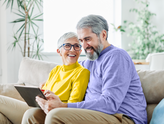 Smiling senior couple on couch